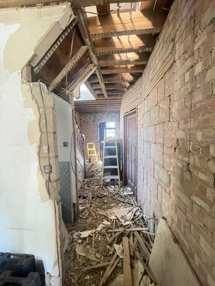 Hallway stripped back to brick and joists